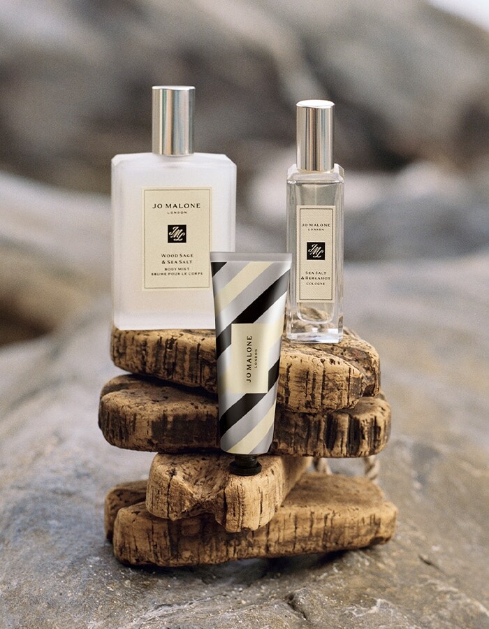 Jo Malone London Wood Sage & Sea Salt body mist, Sea Salt & Bergamot travel spray, and silver striped hand cream.