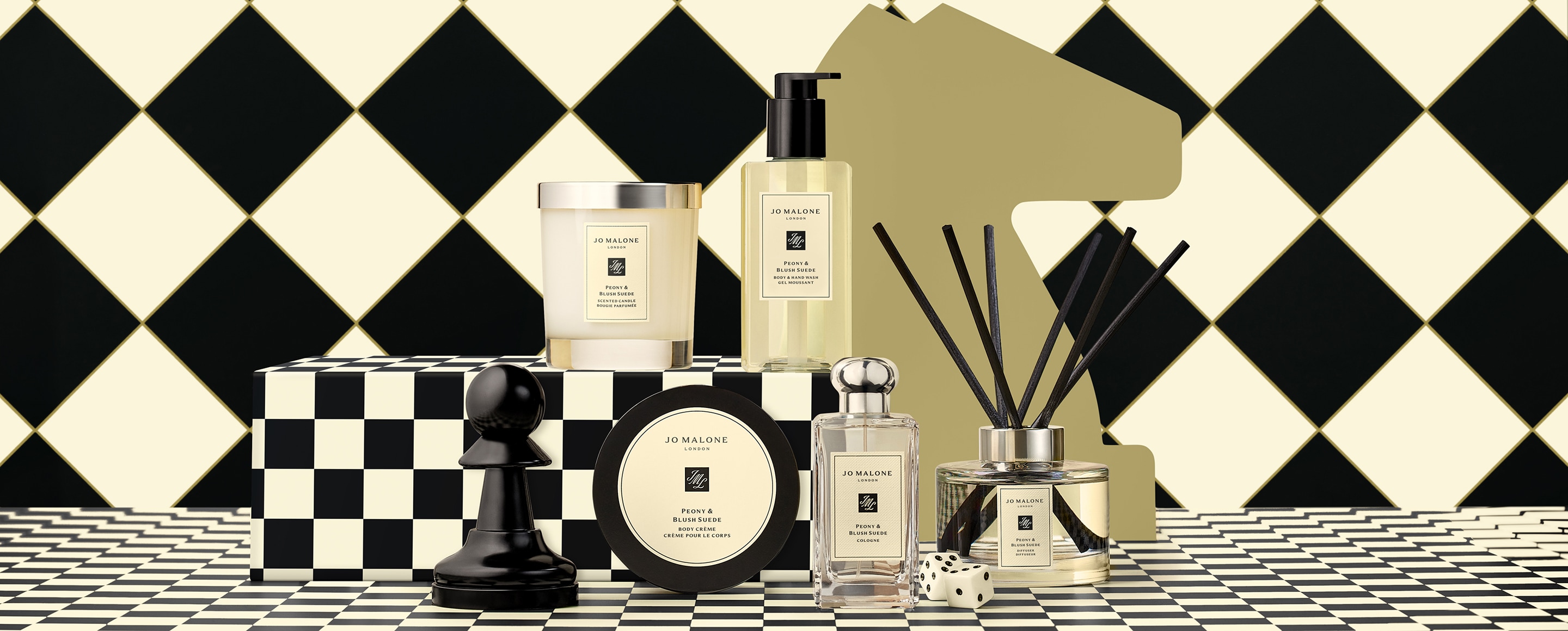 Launch image of advent calendar dartboard box shown open with examples of 5 product contents on checkerboard background.